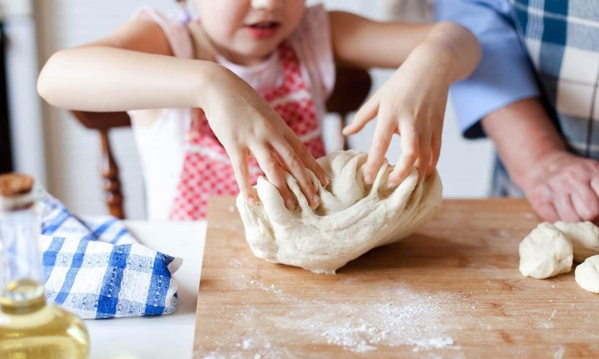 kid playing dough pizza kitchen grandma 1200x720 1